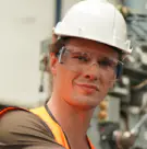 Technician in a white hard hat and safety glasses